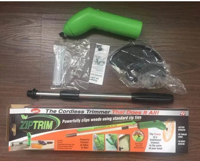 Cordless lawn trimmer with extension pole and protective shield on a garden background