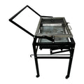 Large foldable portable charcoal grill oven set up in a garden