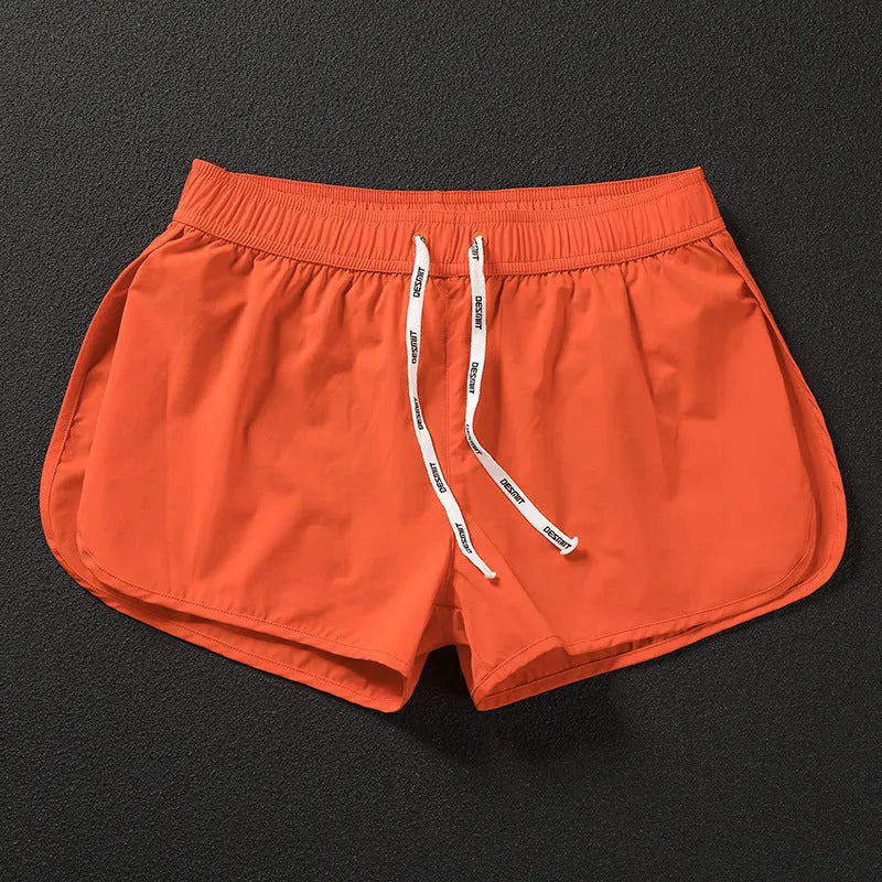 Men's loose fit beach shorts in polyester available in orange red, fluorescent green and black colours