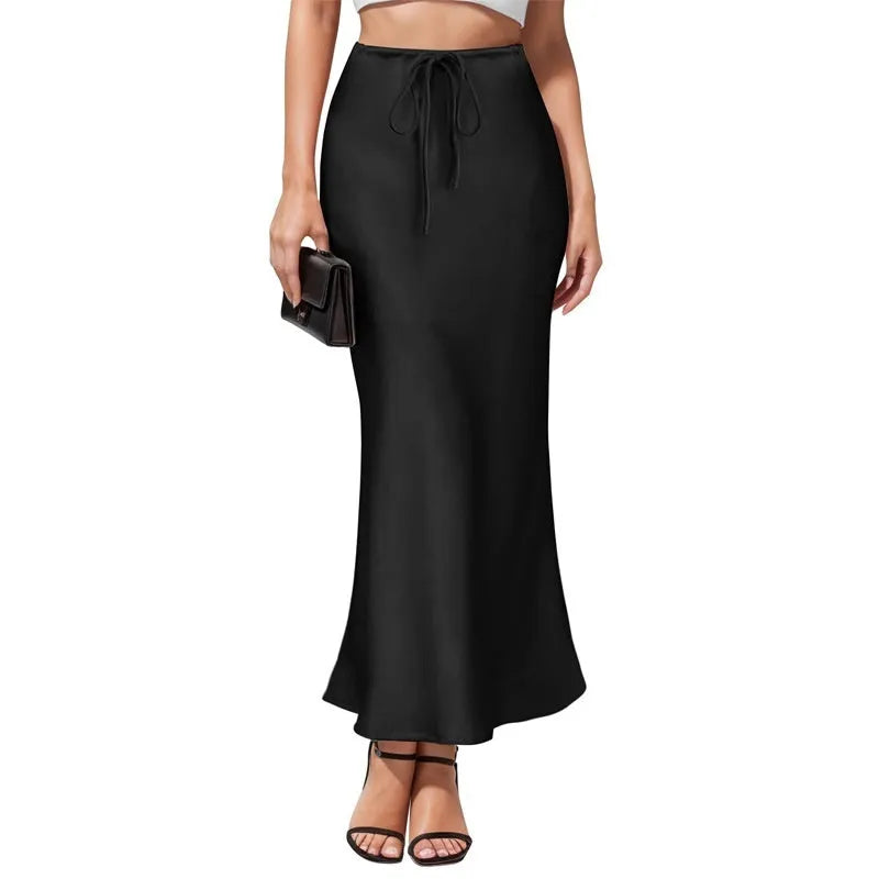 Women's high-waist asymmetric satin skirt in black with irregular stitching detail on the hem.