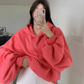 Watermelon red women's loose fit mulberry silk hooded sweater on a hanger.
