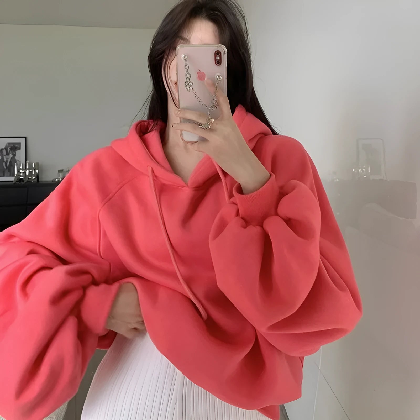 Watermelon red women's loose fit mulberry silk hooded sweater on a hanger.