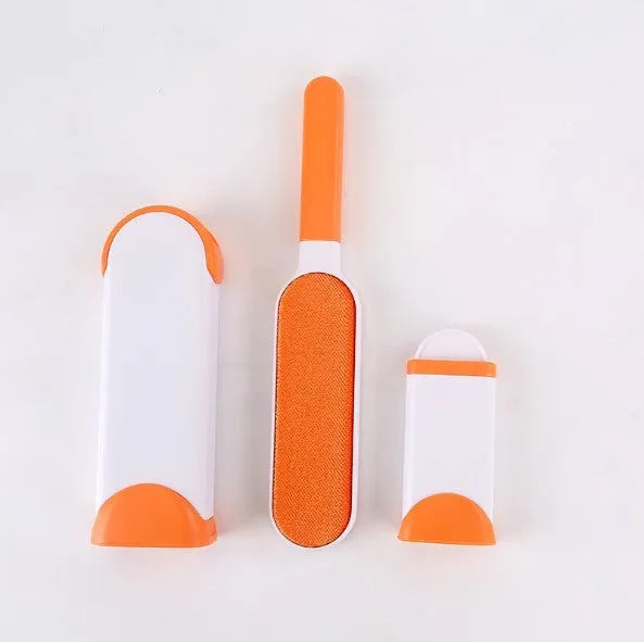 Blue reusable pet hair removal brush with a self-cleaning base, placed on a grey sofa.