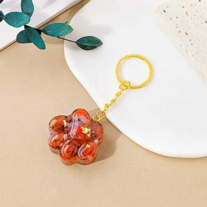 Natural crystal cat's paw keychain pendant in assorted gemstone colours on a keyring.