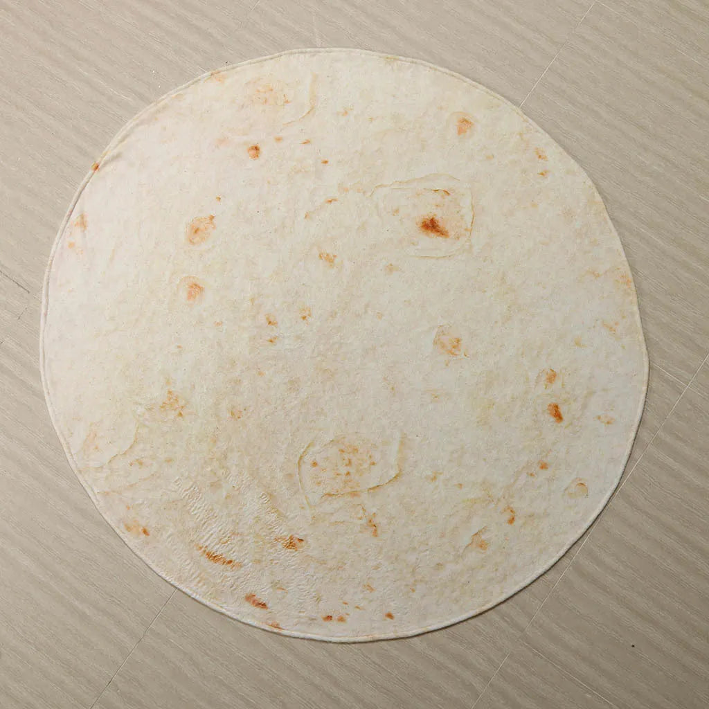 Round coral fleece flannel blanket rolled in a burrito style, showing soft texture and printed design.