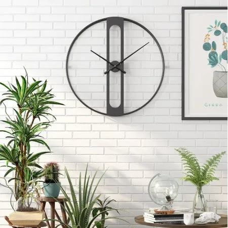 Large round metal wall clock with a 50cm diameter in a black finish on a white wall.