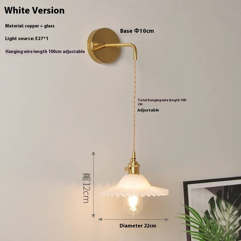 Retro brass lotus wall lamp with a glass shade in a choice of six colours.