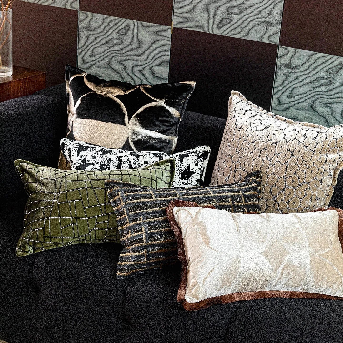 Black gold abstract pattern decorative flannel cushion on a sofa, showing removable cover.