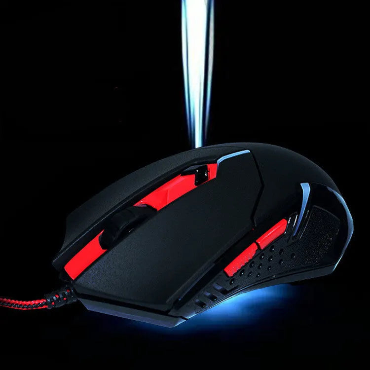 Black and red USB wired gaming mouse with six buttons on a desktop mat.