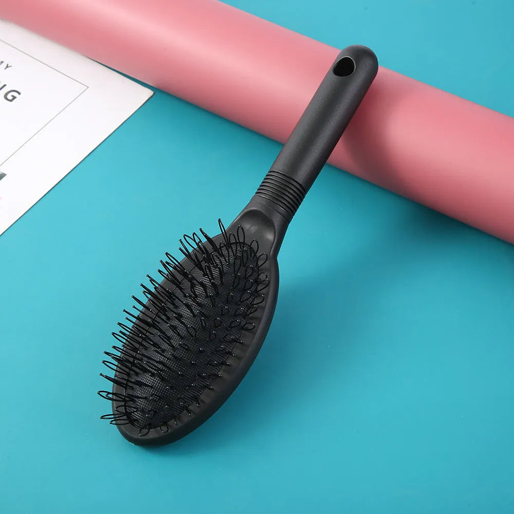Black ring tooth plastic comb with airbag feature for hair extensions, shown next to a pink version.