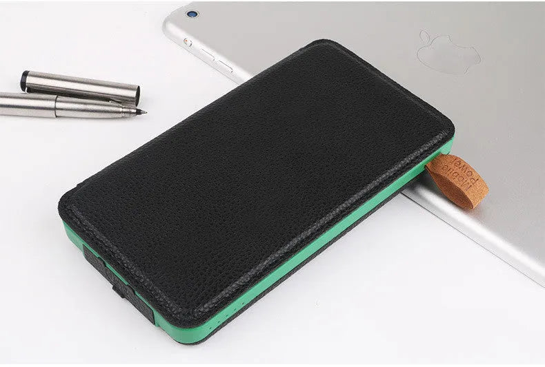 Black solar power bank with leather casing and monocrystalline solar panel showing charging ports and LED light