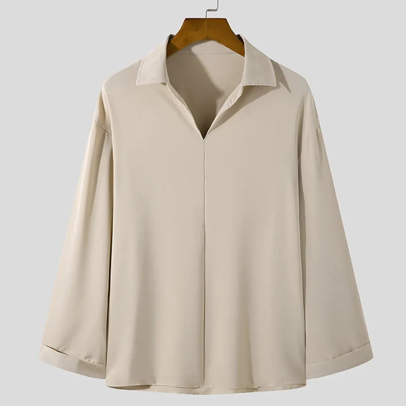 Man wearing a loose lapel pullover casual shirt in a light business style.