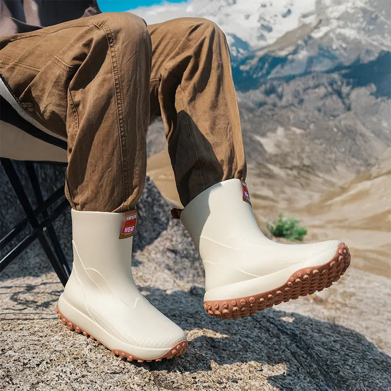 Men's mid and low tube rain boots in black, waterproof PVC with non-slip plastic sole on wet ground
