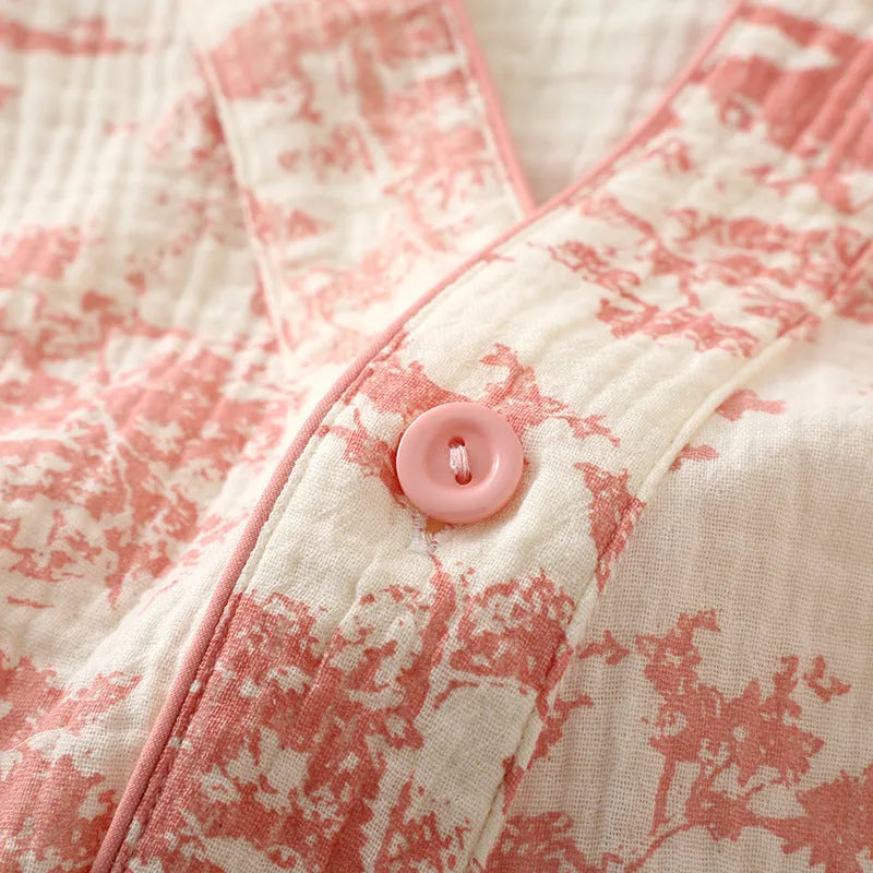 Women's pink pure cotton gauze long sleeve pyjama set with lace-up trousers laid flat.