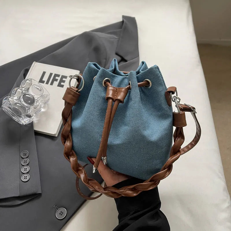 Blue synthetic leather cross-body bucket bag with adjustable strap and sandwich pocket