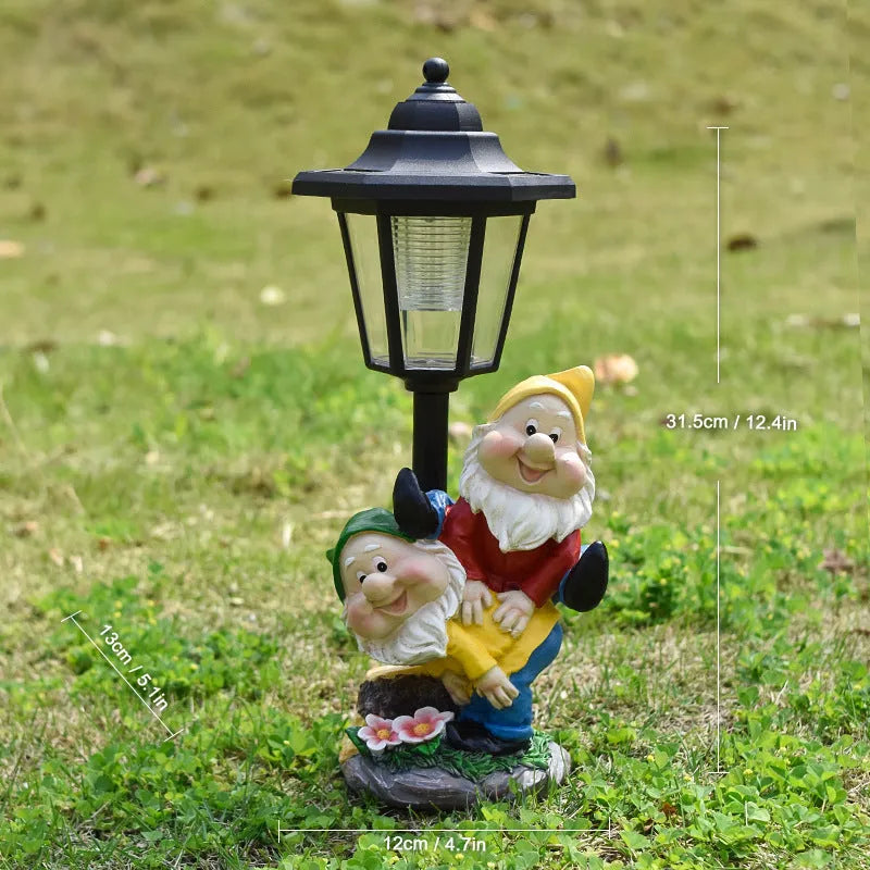 Solar hexagonal garden lamp with decorative resin figurine on plastic base for outdoor pathway lighting