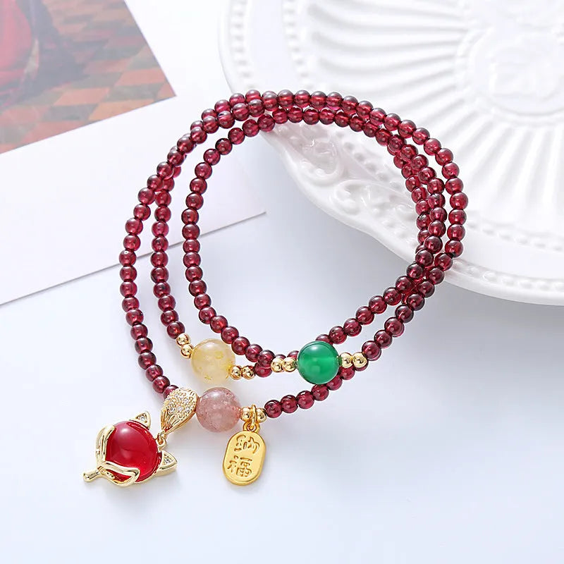 Women's adjustable garnet fox bracelet with rope closure in purplish red colour