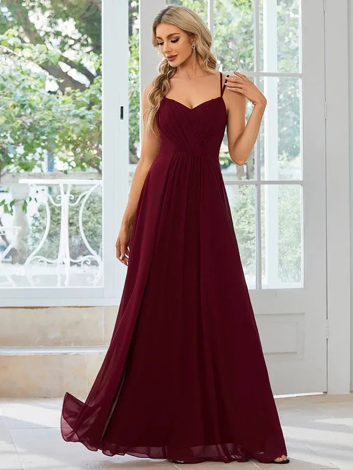 Women's sleeveless pleated A-line dress in light green with sling neckline for banquet occasions