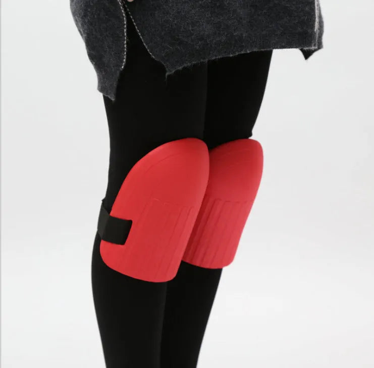 A pair of thick EVA foam knee pads in army green colour on grass.