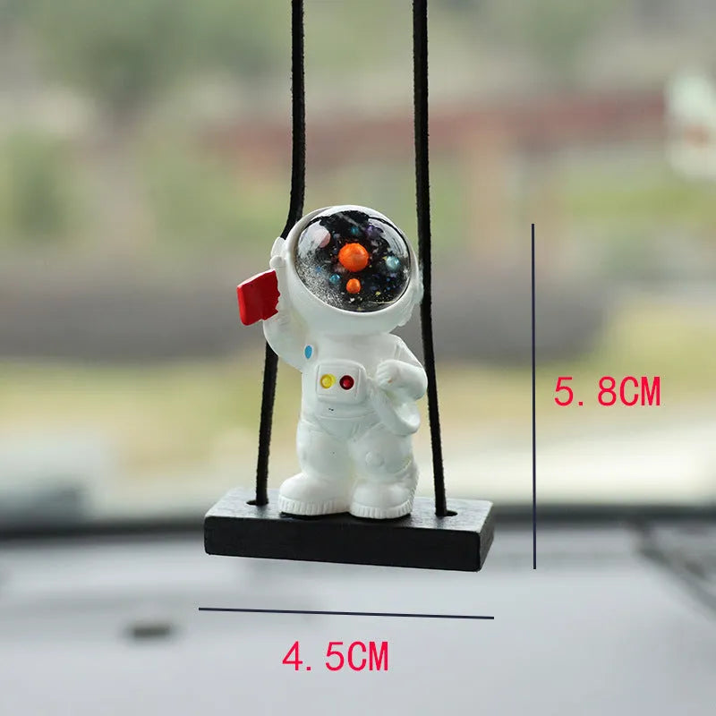 Resin astronaut car pendant in one of five cartoon colour designs