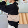 Women's black PU leather crossbody bag with butterfly chain shoulder strap showing internal phone pocket