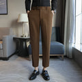 Men's brown straight-leg corduroy trousers with an elasticated waistband laid flat.