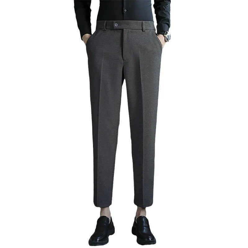 Men's brown straight-leg corduroy trousers with an elasticated waistband laid flat.