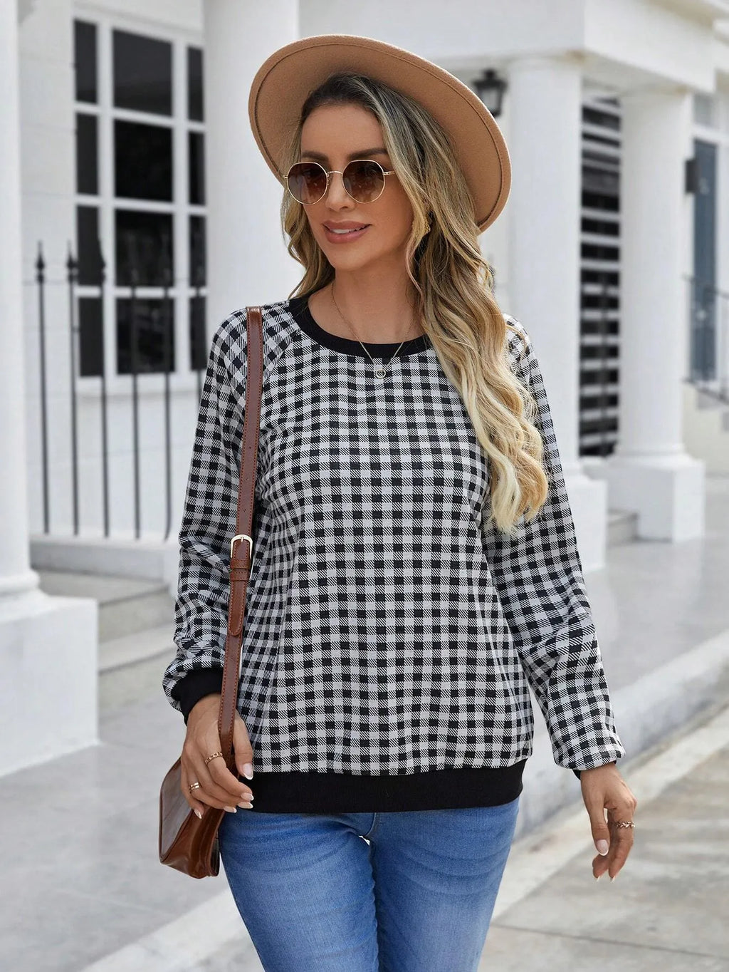 Black Japanese plaid pattern long sleeve polyester pullover sweater on a hanger