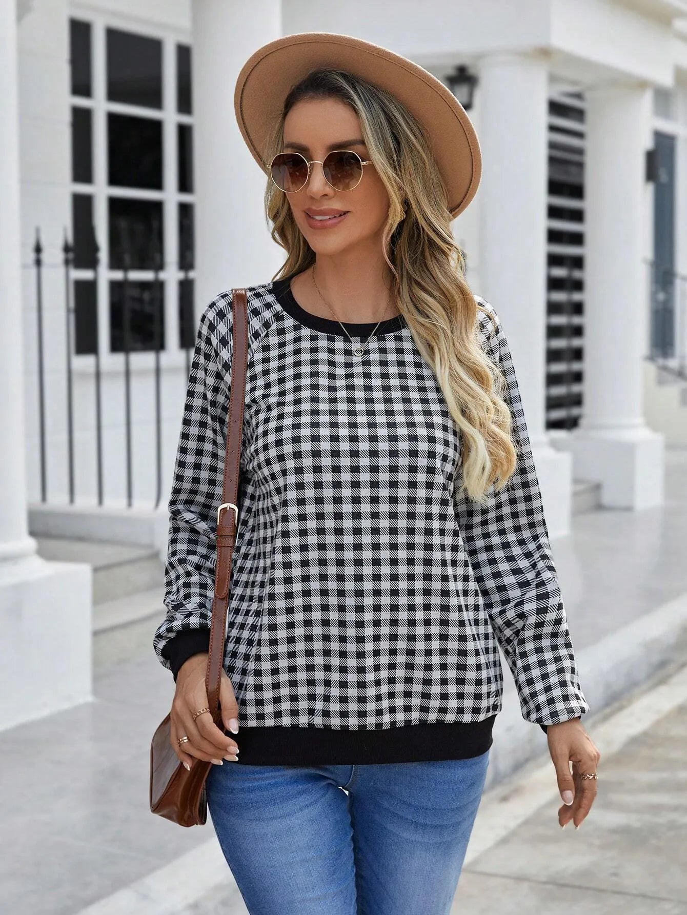 Black Japanese plaid pattern long sleeve polyester pullover sweater on a hanger