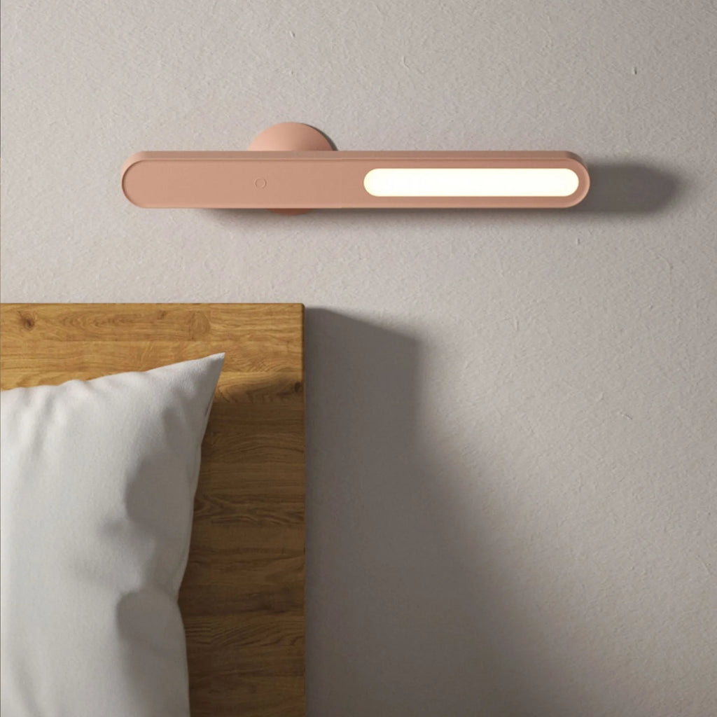White geometric table lamp with touch switch and USB cable on a wooden desk.