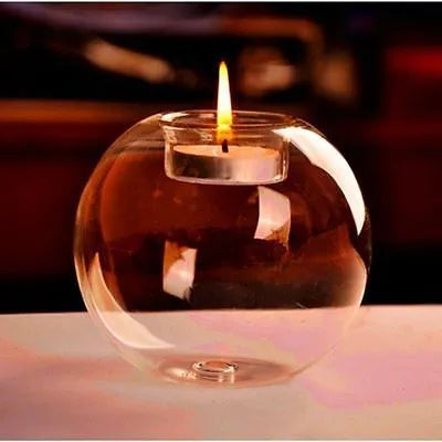 Clear round hollow glass candle holder for a tea light on a table