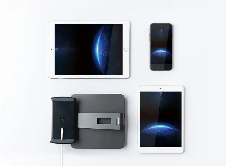 Folding aluminium desktop phone and tablet stand with 360-degree rotation on a wooden desk.