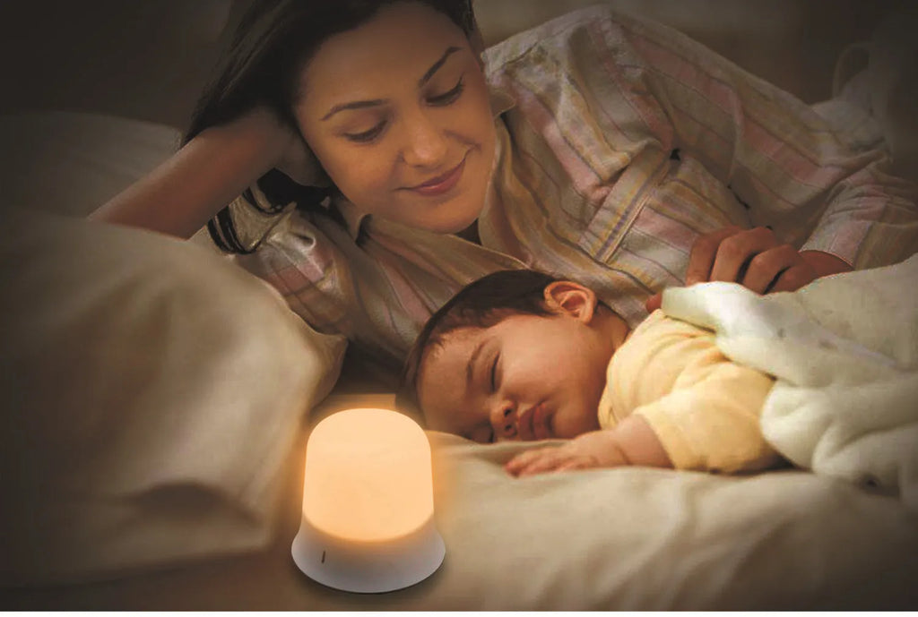 White touch-control bedside night light with motion sensor and rechargeable battery on a table.