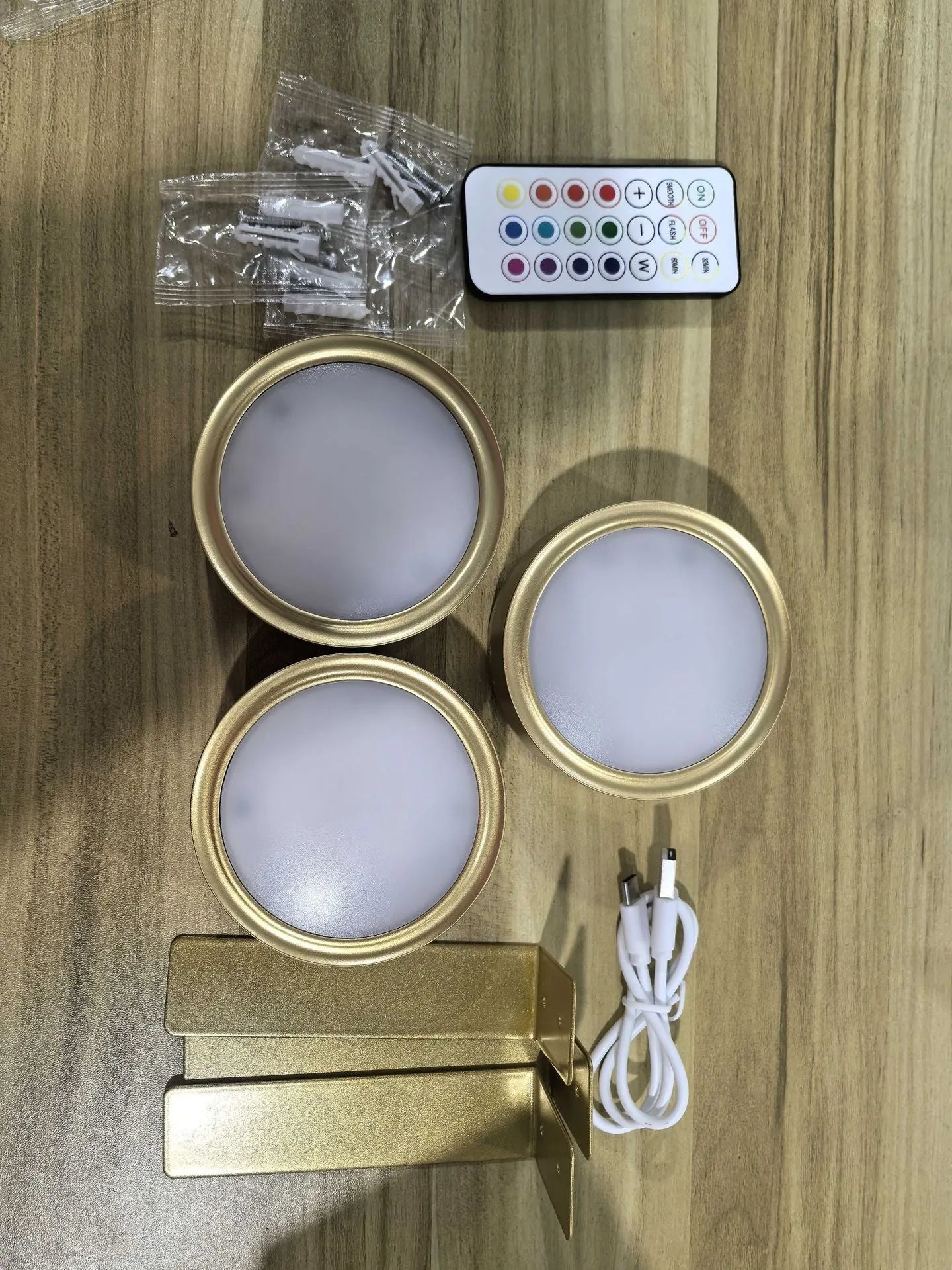 Wireless rechargeable LED painting lamp with magnetic belt attached to a metal frame, remote control nearby.
