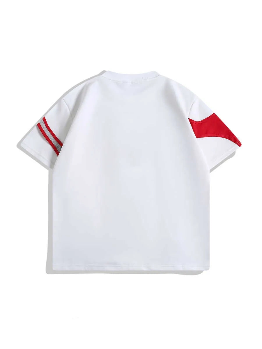 Man's black short sleeve T-shirt showing detail of double stitching and padded shoulder on a hanger.