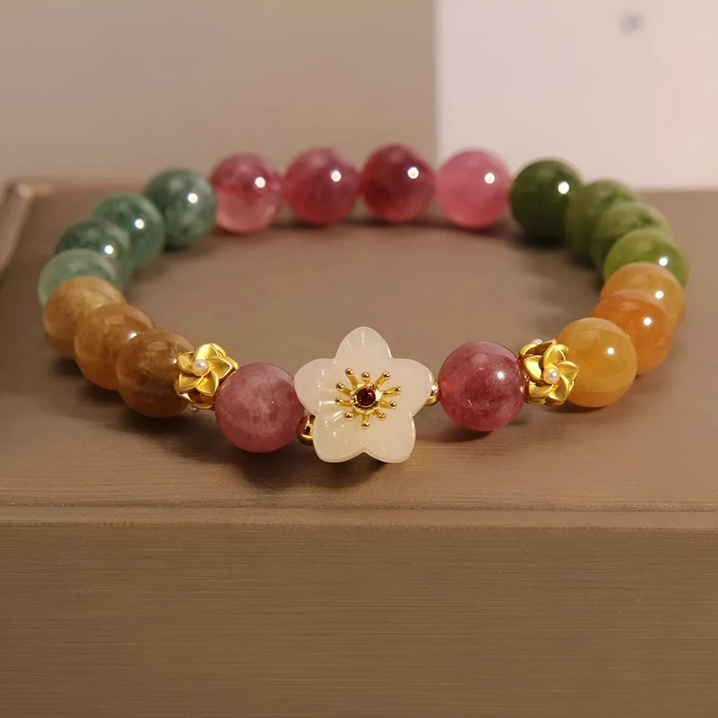 Electroplated tourmaline bracelet with flower and fu character pendant designs in natural colours