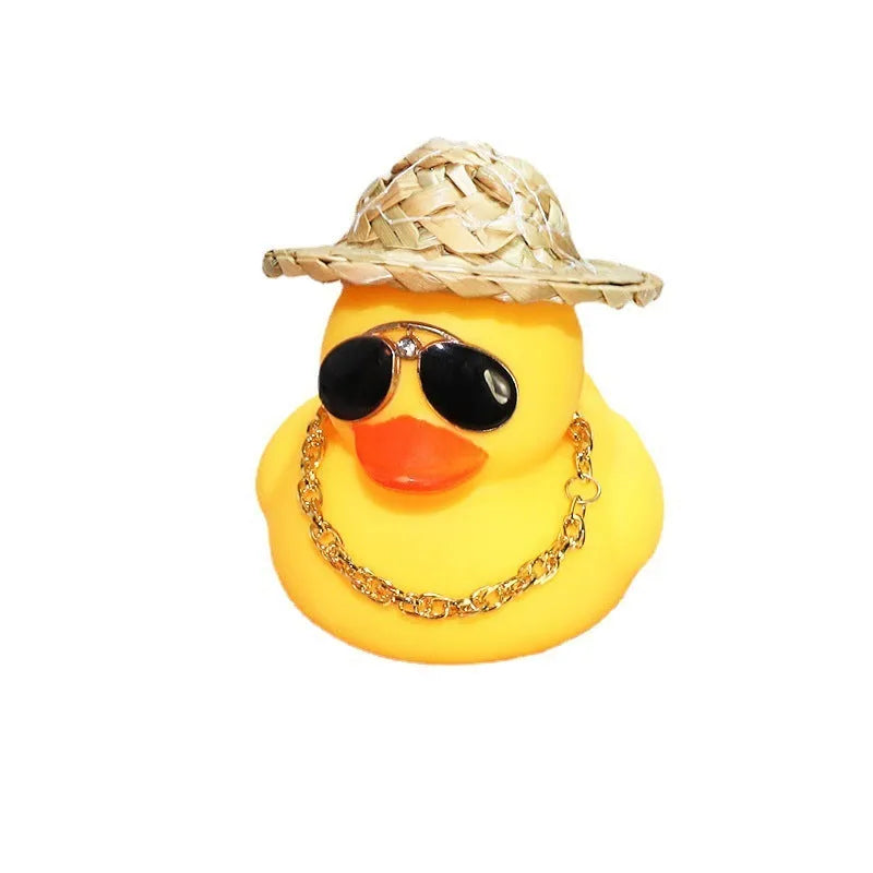 Yellow cartoon Straw Hat Duck car dashboard ornament with matte finish on a car interior.