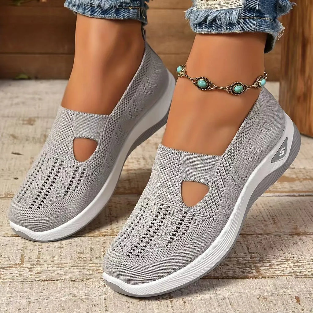 Women's black casual mesh shoes with T-strap and flat soft sole.