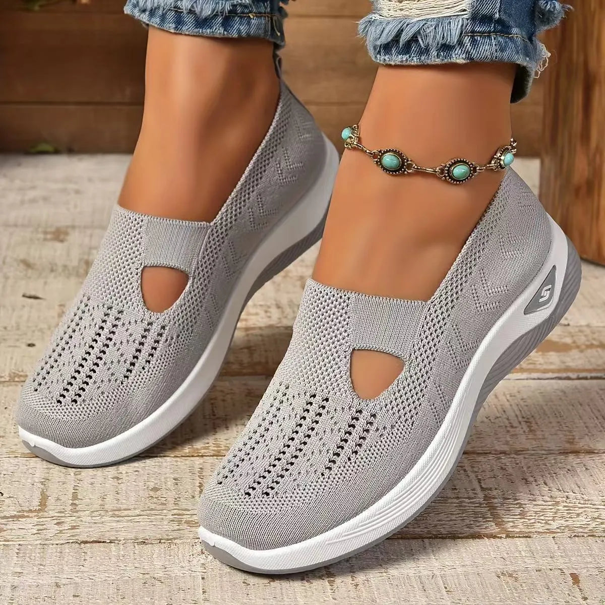 Women's black casual mesh shoes with T-strap and flat soft sole.