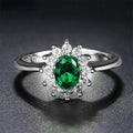 Women's blue moissanite and copper floral ring on a finger, showing zirconium inlay and electroplated colour.