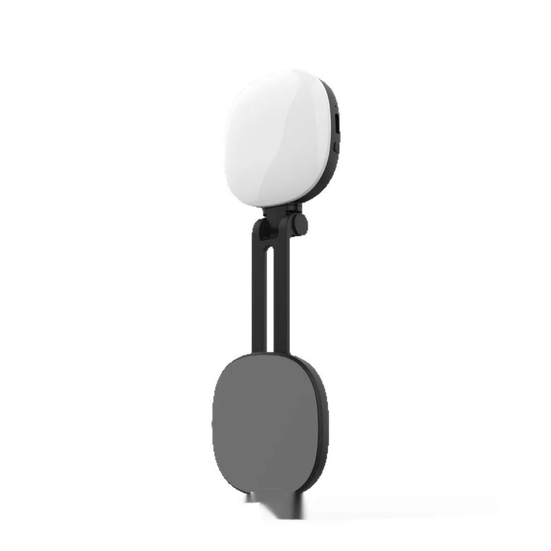 Black mini portable fill light with dial control magnetically attached to a mobile phone.