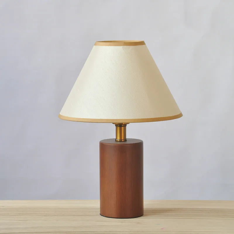 Brown cylindrical wooden bedside lamp with beige cover and E14 bulb base