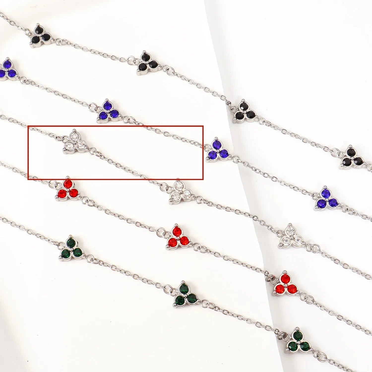 Women's stainless steel geometric bracelet with triangle elements and coloured stone settings