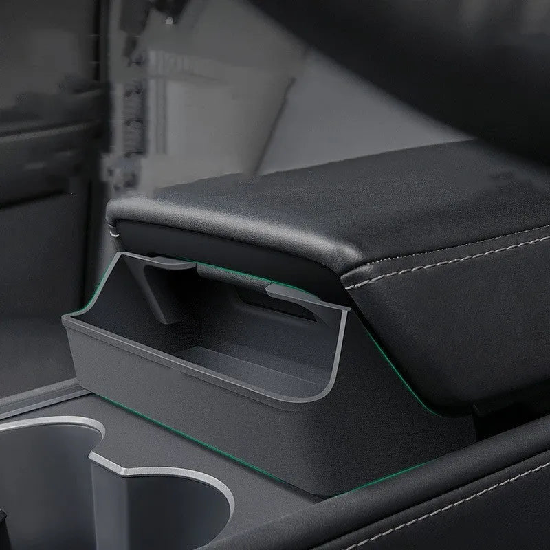 Black silicone glasses storage case installed in a Tesla Model 3 or Y centre console armrest.