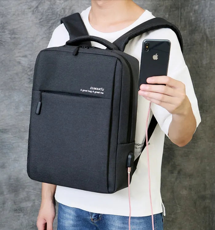 Waterproof rechargeable backpack laptop bag in black for a 15.6-inch computer.