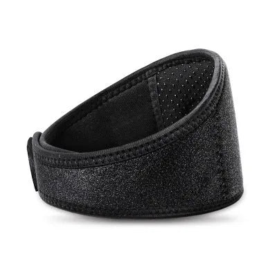 Black self-heating magnetic therapy neck guard with adjustable strap on a flat surface.