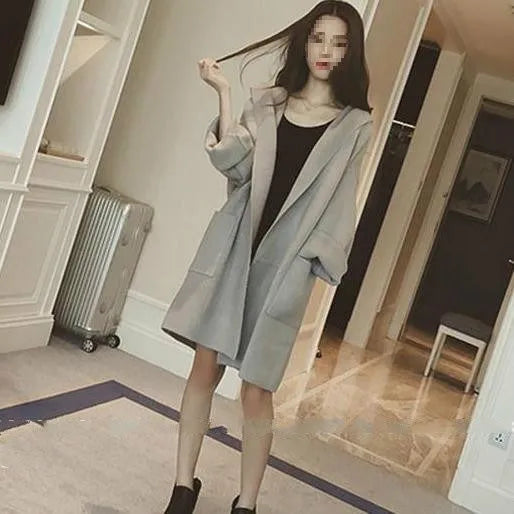 Plus size woman wearing a thin grey cotton coat with lace detail, loose fit, and long sleeves.