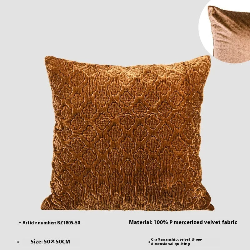 Brown gold antique style three-dimensional quilted cushion pillow on a sofa.