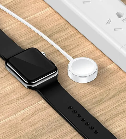 White metal Apple Watch wireless charger with 1m USB cable on a table