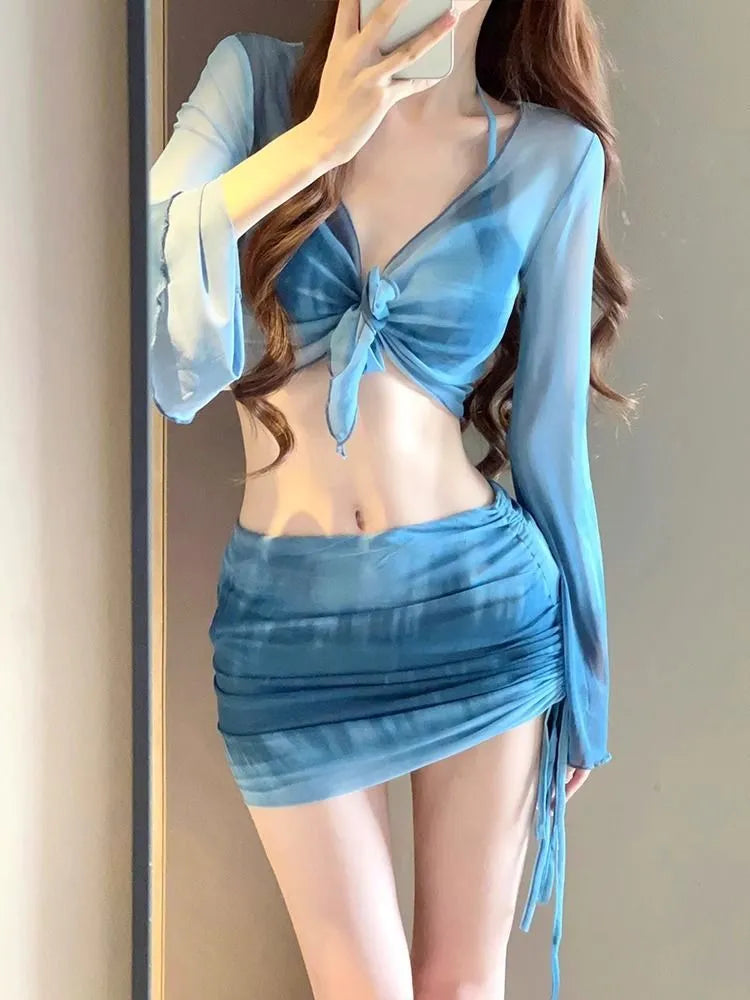 Women's blue four-piece bikini swimsuit set with high-waisted briefs, shirt, and skirt on mannequin